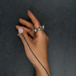 Contemporary silver ring 'KUILUUN' – worn on hand, bold form with cavernous texture and sculptural depth