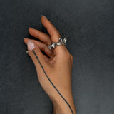 Contemporary silver ring 'KUILUUN' – worn on hand, bold form with cavernous texture and sculptural depth