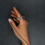 Sculptural silver ring 'KUILUUN' by Myon Rox – bold design with deep-set pattern and shadow effect, on hand