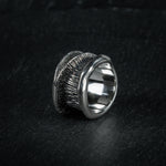 Statement ring 'Talon' by Myon Rox – curved silhouette and waterfall-inspired texture, standing on slate