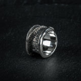 Statement ring 'Talon' by Myon Rox – curved silhouette and waterfall-inspired texture, standing on slate
