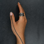 Contemporary silver ring 'Talon' – flowing lines and organic texture, worn on hand
