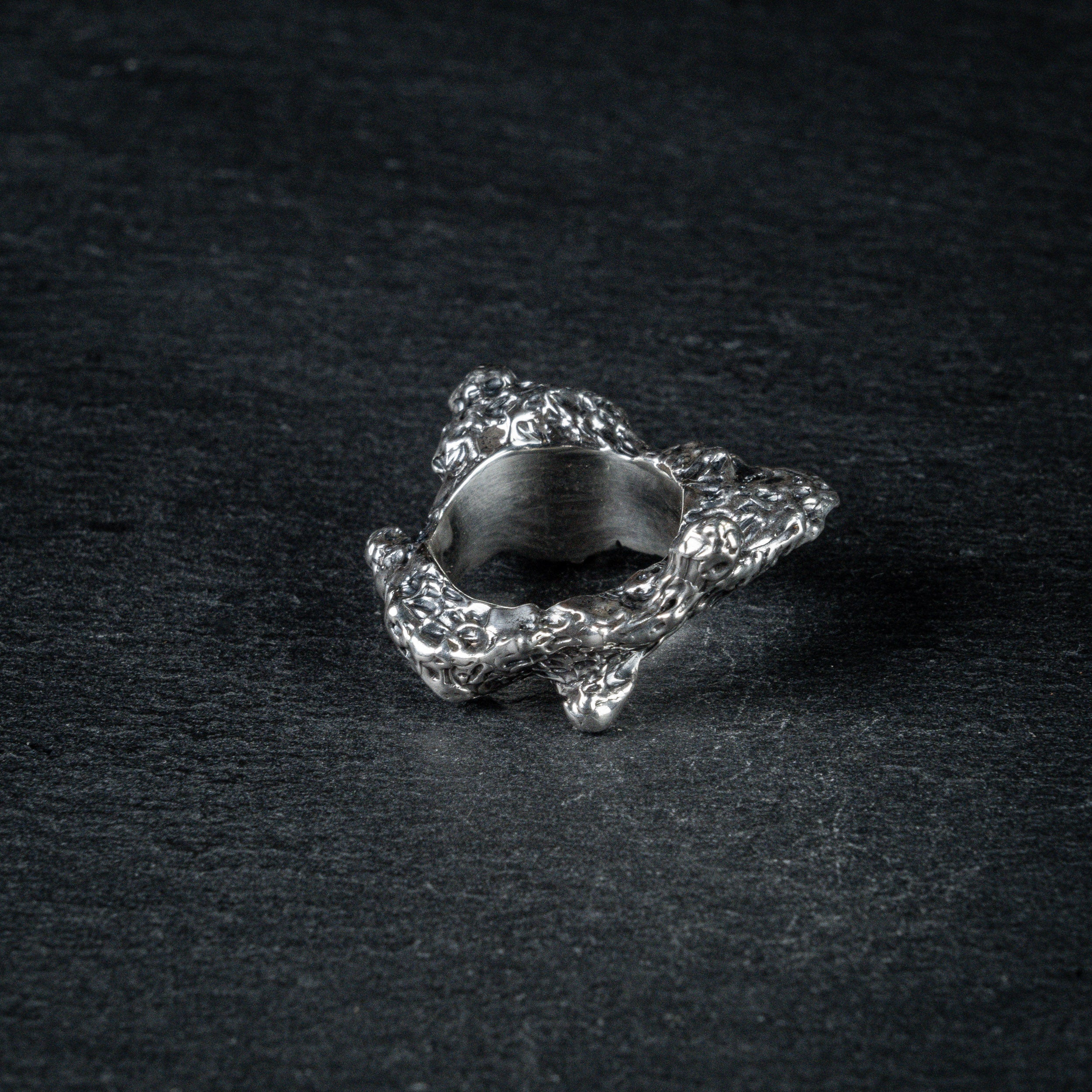 Sculptural silver ring 'Tephra' by Myon Rox – asymmetric open band, molten texture, unisex design, back view