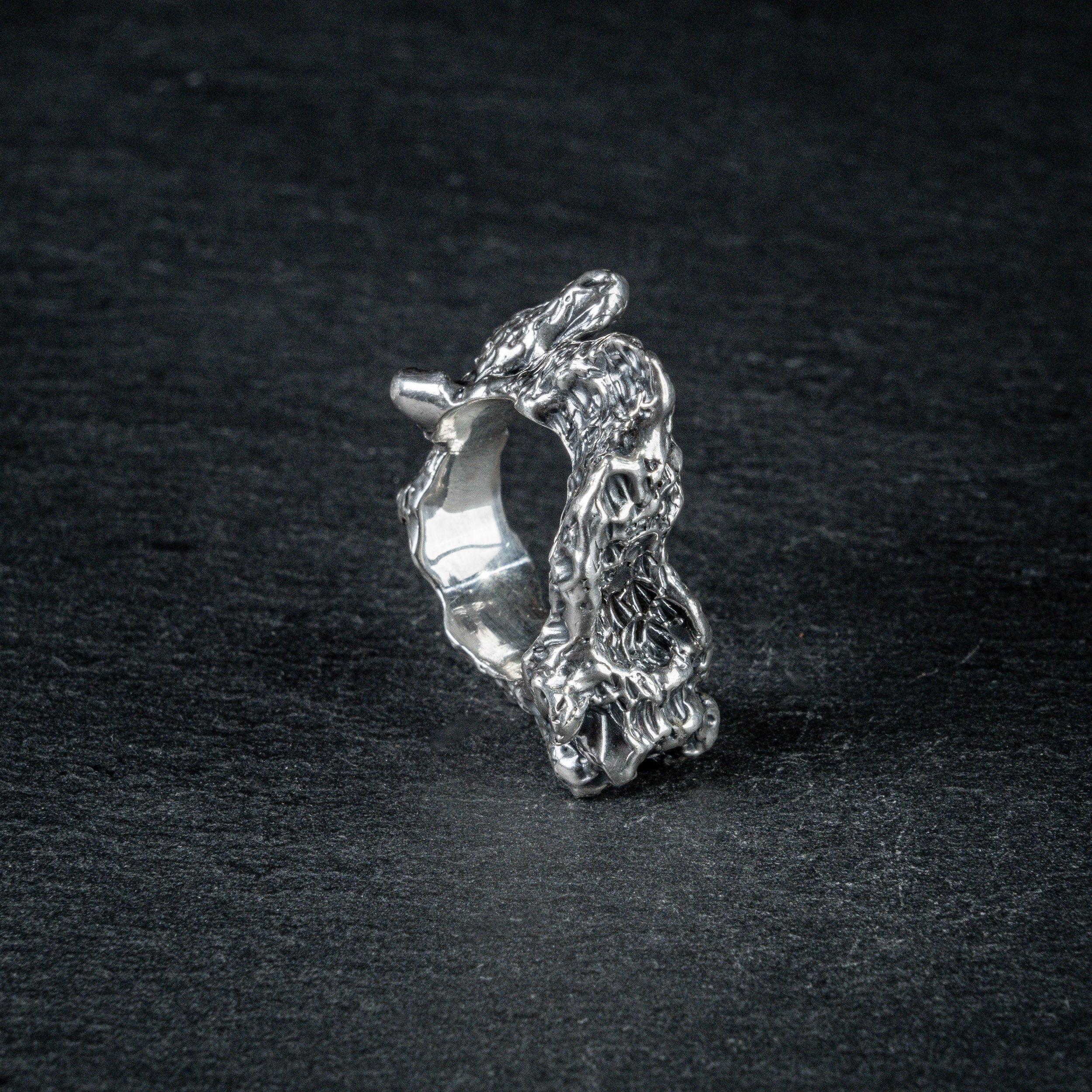 Sculptural silver ring 'Tephra' by Myon Rox – asymmetric open band, molten texture, unisex design, front view