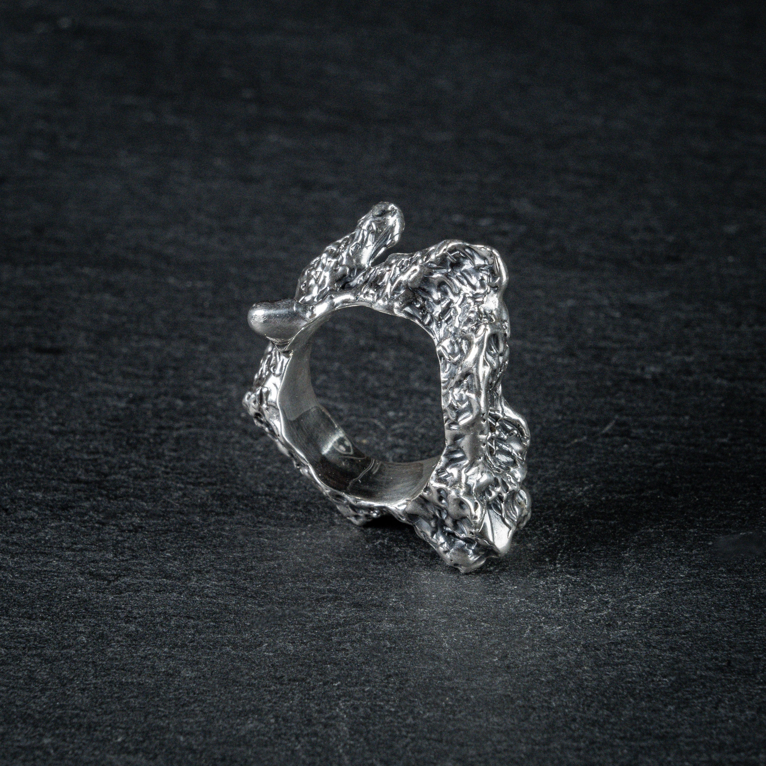 Sculptural silver ring 'Tephra' by Myon Rox – asymmetric open band, molten texture, unisex design, side view