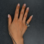 Sculptural silver ring 'Tephra' by Myon Rox – asymmetric open band, molten texture, unisex design, on hand