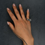 Sculptural silver ring 'Tephra' by Myon Rox – asymmetric open band, molten texture, unisex design, on hand upwards