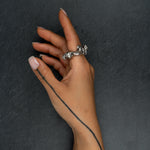 Contemporary silver ring 'KUILUUN' – worn on hand, bold form with cavernous texture and sculptural depth