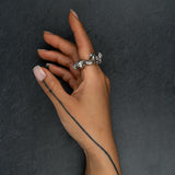 Contemporary silver ring 'KUILUUN' – worn on hand, bold form with cavernous texture and sculptural depth