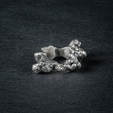 Side view of silver ring 'KUILUUN' – dramatic, abyss-inspired design with shadowed inner structure