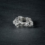 side view of sculptural ring 'KUILUUN' – open band and bold contours inspired by geological forms
