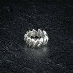ASCEY silver ring with bold jagged spine-inspired design on dark slate, front viewASCEY silver ring with bold jagged spine-inspired design on dark slate, front view