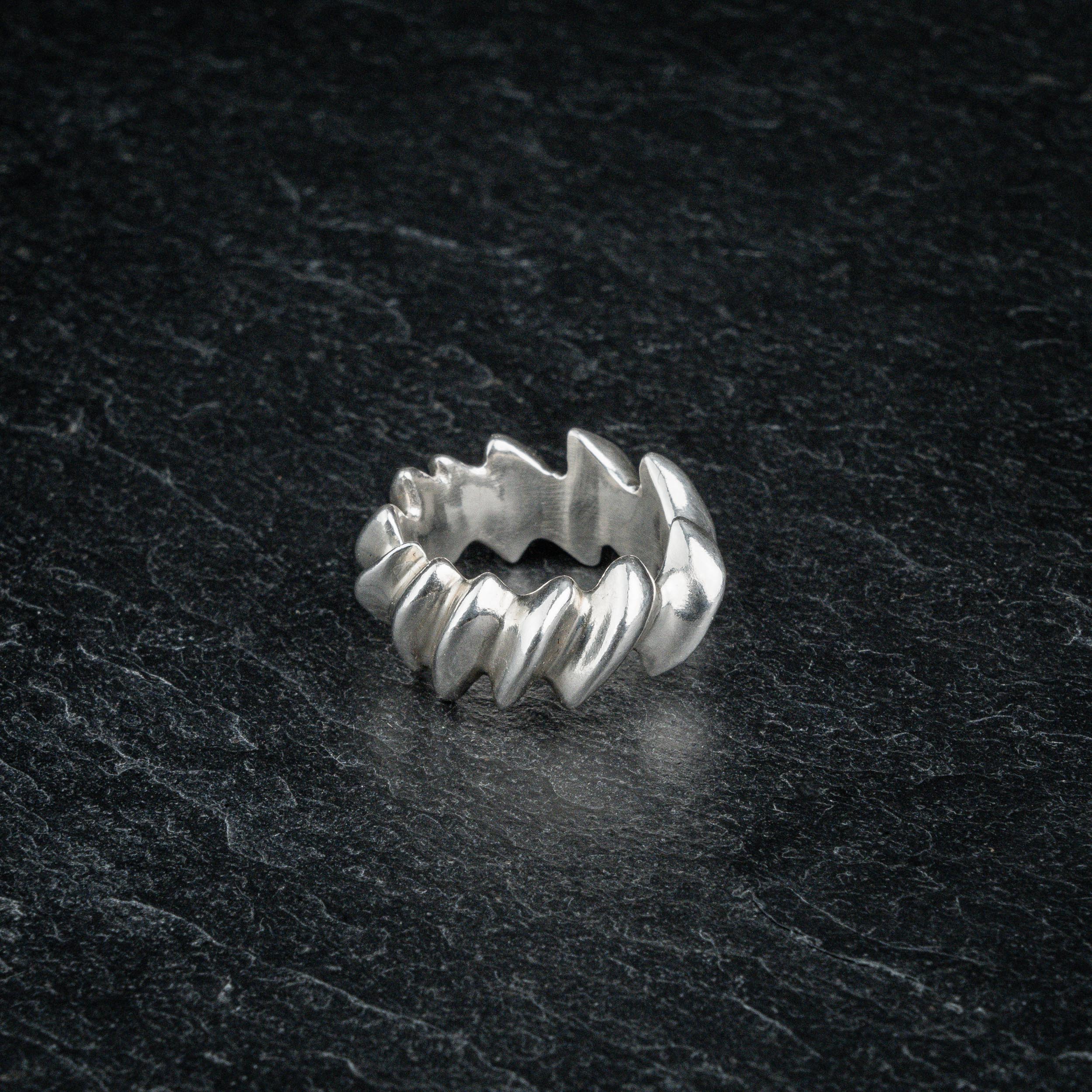 ASCEY silver ring with bold jagged spine-inspired design on dark slate, front viewASCEY silver ring with bold jagged spine-inspired design on dark slate, front view