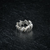 ASCEY silver sculptural ring with bold jagged spine design on dark slate, top viewASCEY silver sculptural ring with bold jagged spine design on dark slate, top view