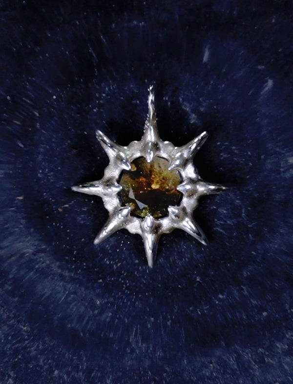 Instagram video showing the NYOTA pendant as a water droplet falls into water, creating circular ripples that expand outward from the center in slow motion.