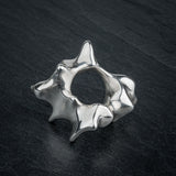 SYRINX organic massive silver sculptural statement ring on dark slate, top view