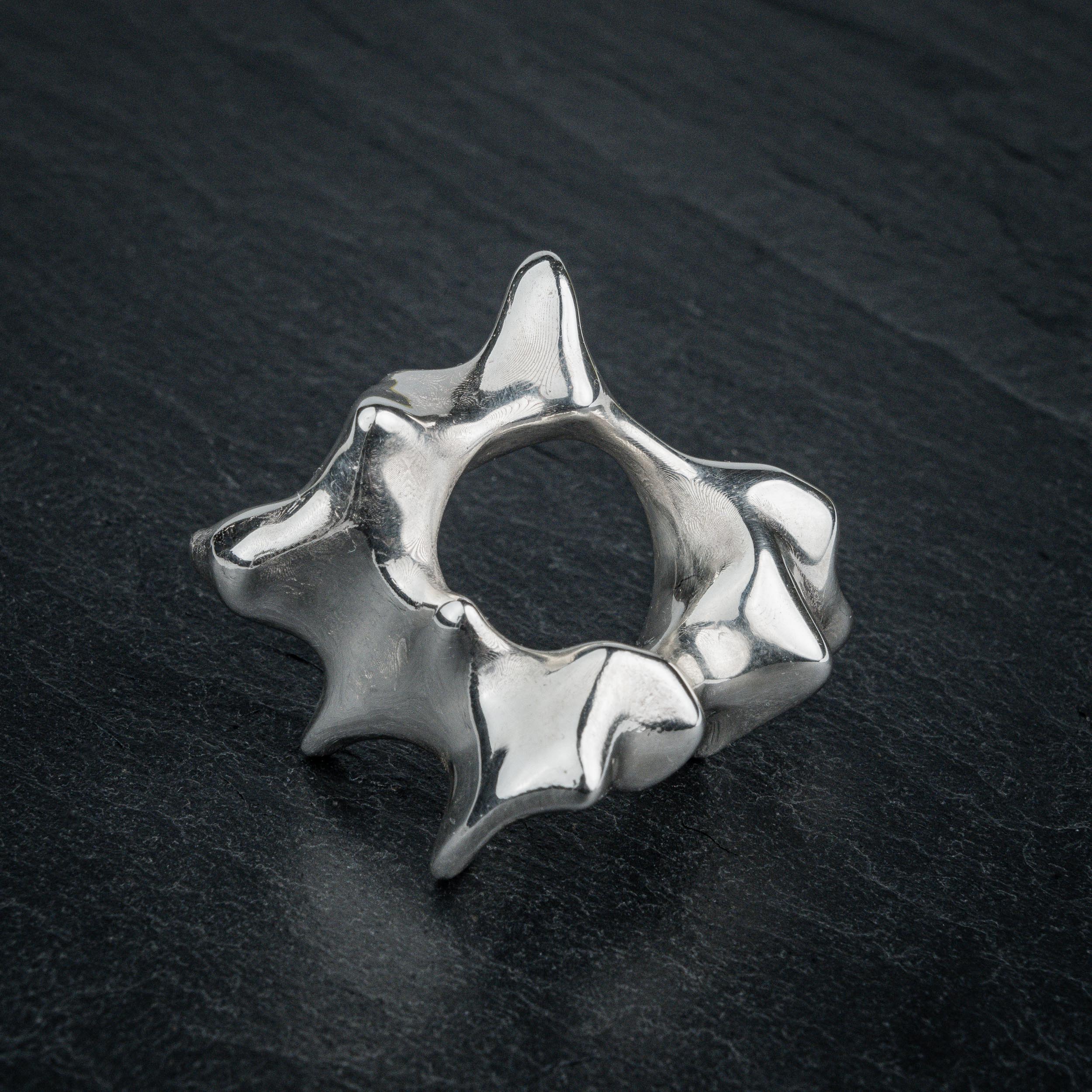 SYRINX organic massive silver sculptural statement ring on dark slate, top view