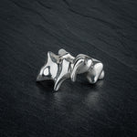 SYRINX organic massive silver sculptural statement ring on dark slate, front view