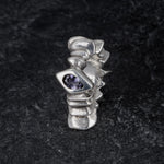 TRANSIT massive silver ring with stepped pattern and central iolite gemstone on slate, front view