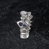 TRANSIT massive silver ring with stepped pattern and central iolite gemstone on slate, front view