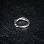 TRI_M72 single silver Möbius strip ring featuring 720 degree twist, solo on slate