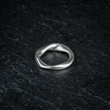 TRI_M72 single silver Möbius strip ring featuring 720 degree twist, solo on slate