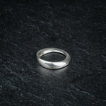 TRI_M18 single silver Möbius strip ring featuring 180 degree twist, solo on slate