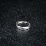 TRI_M18 single silver Möbius strip ring featuring 180 degree twist, solo on slate