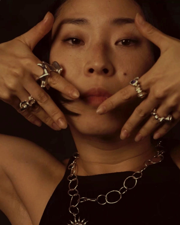 Instagram video titled “Flow Symbiosis” showing a female dancer wearing different MYON ROX sterling silver rings while moving against a dark background, highlighting sculptural and organic ring forms.